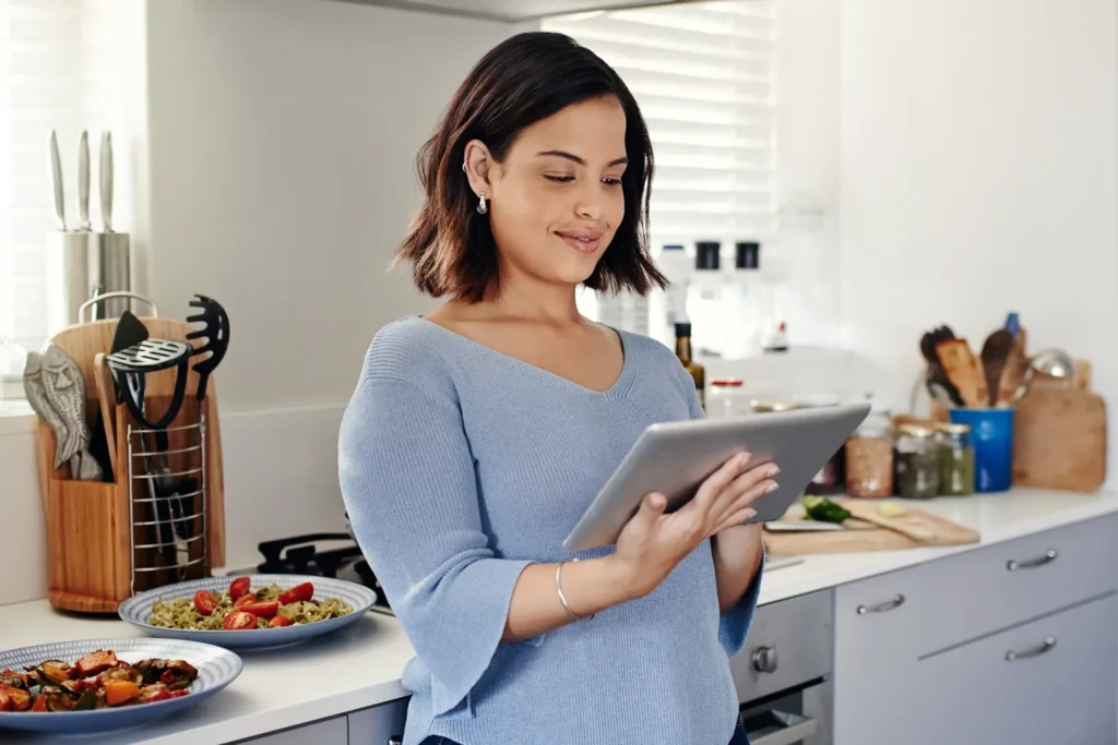 Young woman cooking in a home kitchen.