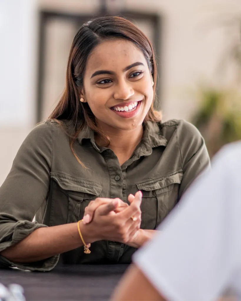 Young female patient having a thyroid consultation with a holistic healthcare provider.